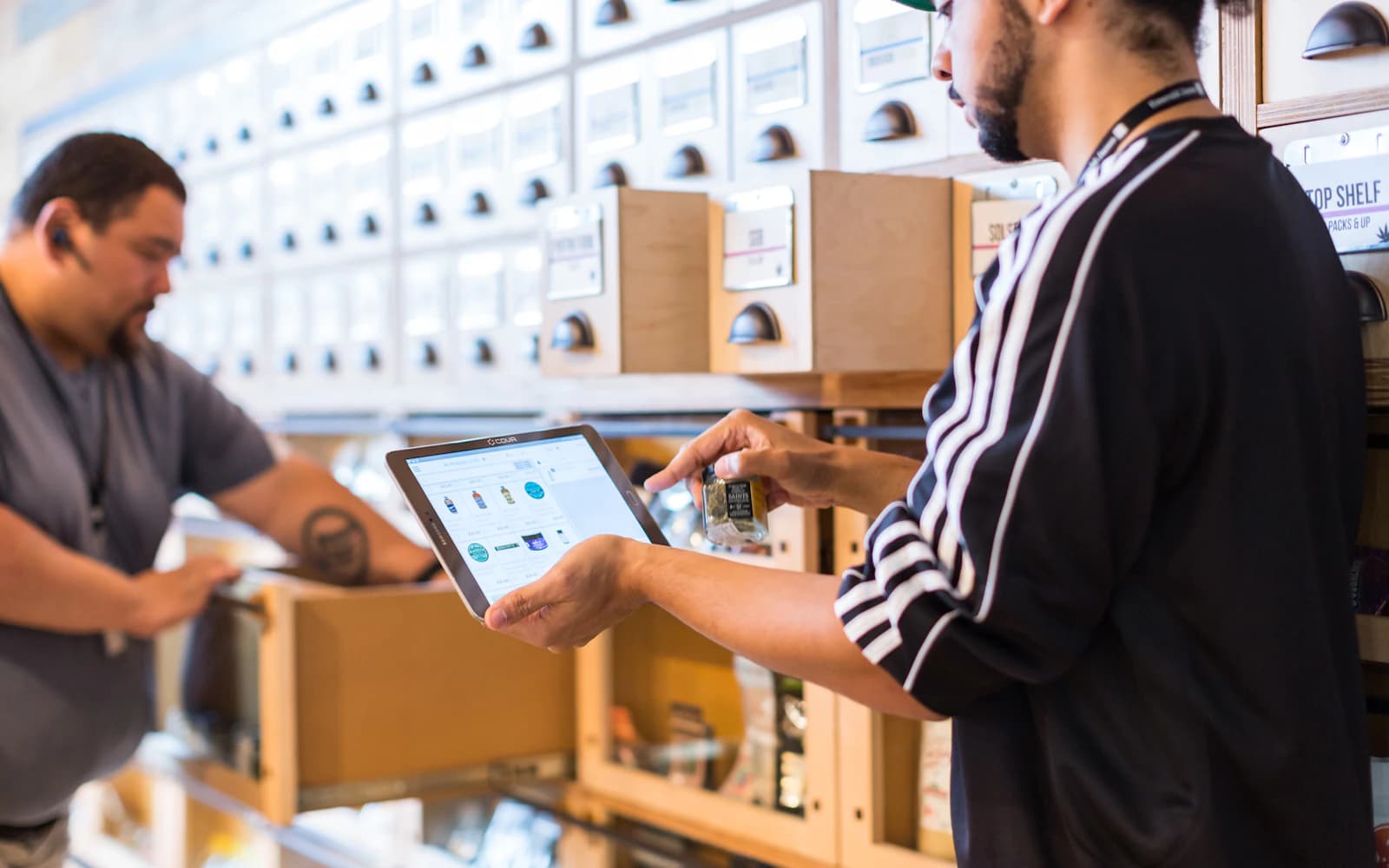 Retail team using a tablet to manage products and inventory
